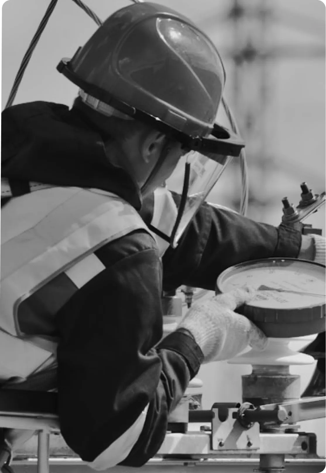 A Tetris Energies technician in protective gear servicing equipment.